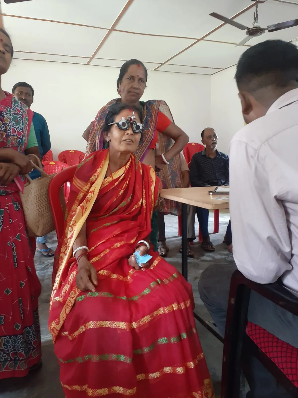 Elderly woman receiving trial lens eye refraction test.